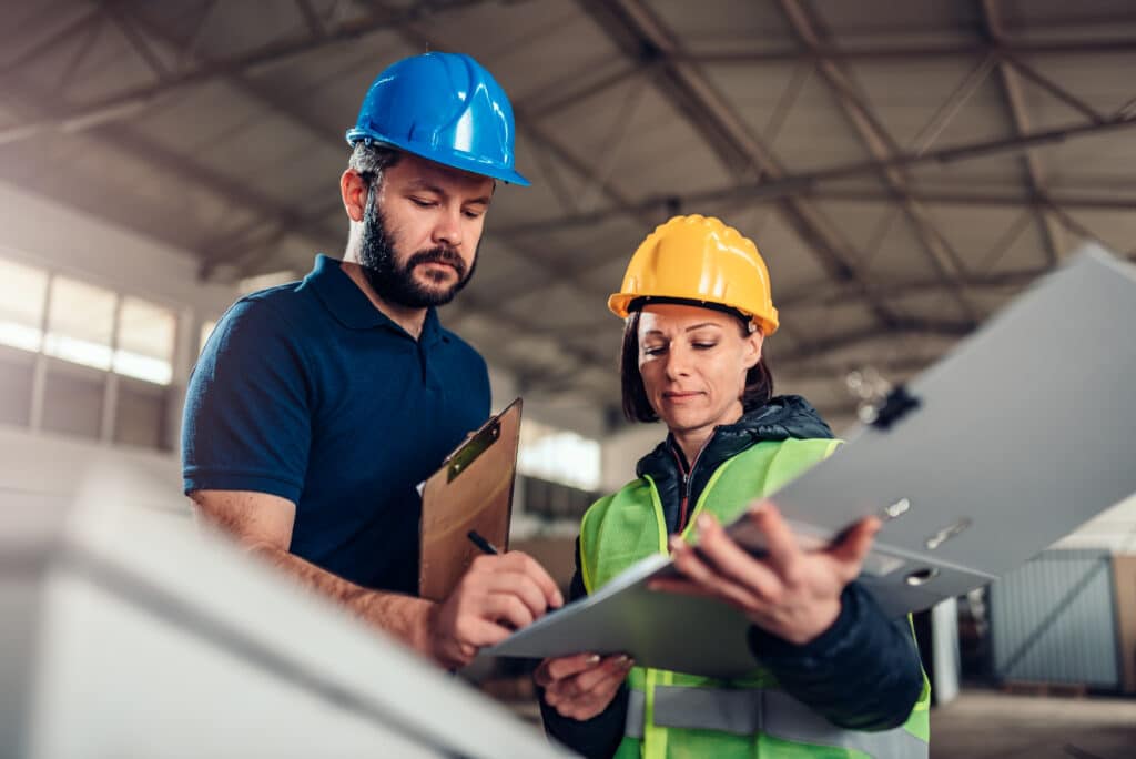 Factory,Worker,Signing,Document,In,Industrial,Hall