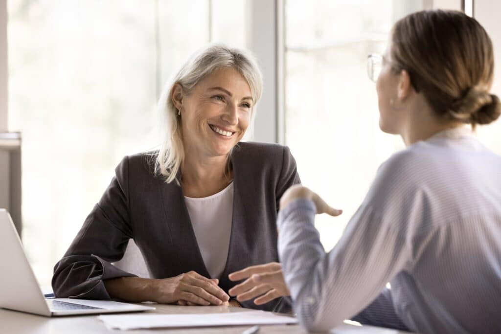 35s,And,Middle-aged,50s,Businesswomen,Having,Conversation,In,Company,Office,