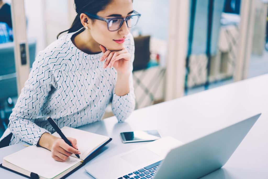 Pensive,Female,Administrative,Assistant,Checking,Report,On,Laptop,Reading,Information