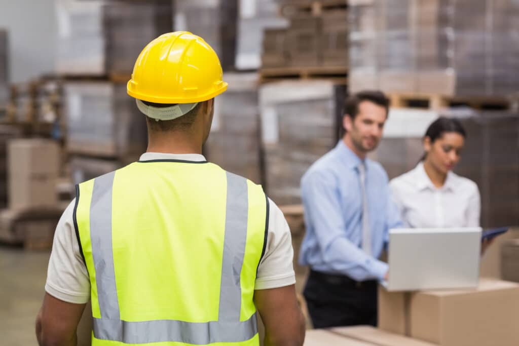 Rear,View,Of,Warehouse,Worker,In,Front,Of,His,Managers