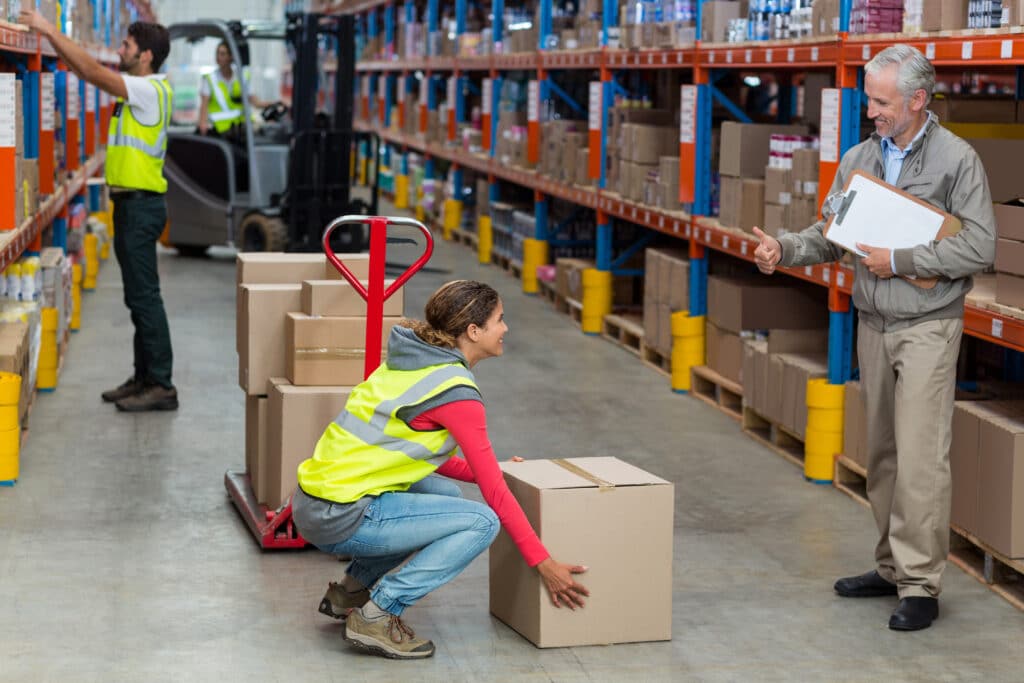 Manager,Looking,A,Worker,With,Thumbs,Up,In,A,Warehouse